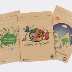 Three eco-friendly paper bags with unique printed designs: one bag shows a green eco-theme with text about sustainability, another features colorful cartoon animals with the phrase '...enjoy the WOW,' and the third depicts a minimalist nature scene with mountains, trees, and a bright sun.