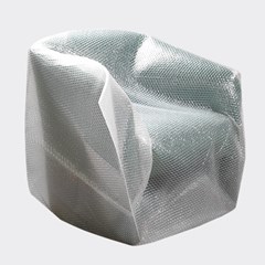 Image of a chair wrapped in centerfold lamination, providing protective cushioning for furniture during moving or storage.